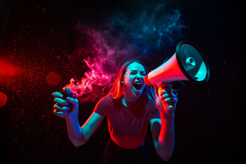 shouting-with-megaphone-young-woman-with-smoke-neon-light-black-background-highly-tensioned-wide-angle-fish-eye-view